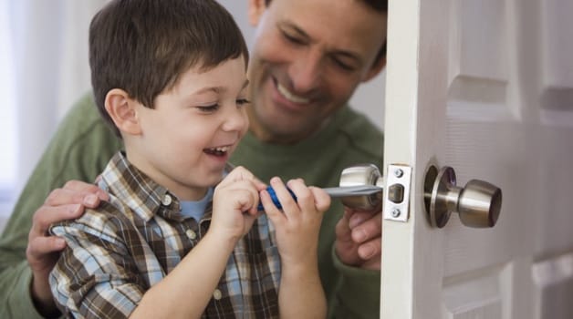 Father and son unlocking door